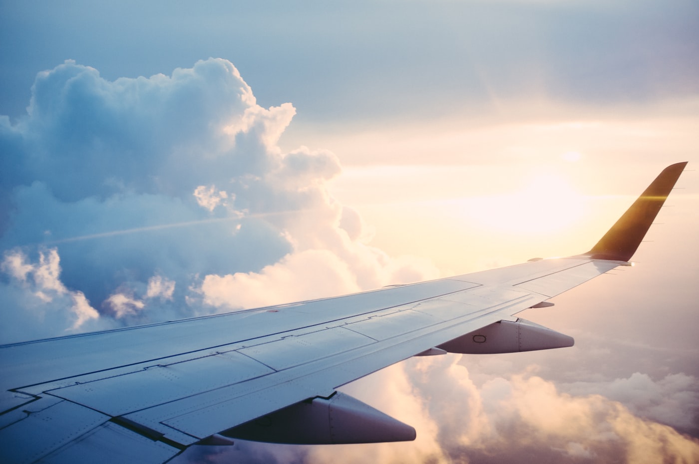 Airplane in flight over clouds during medical travel